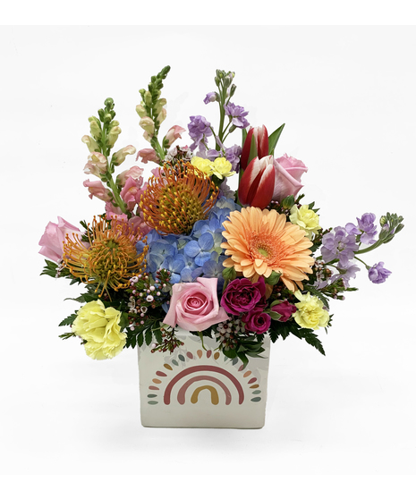 vivid and unique flower arrangement in rainbow cube