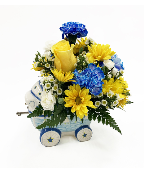 yellow and blue flowers in pram shaped vase