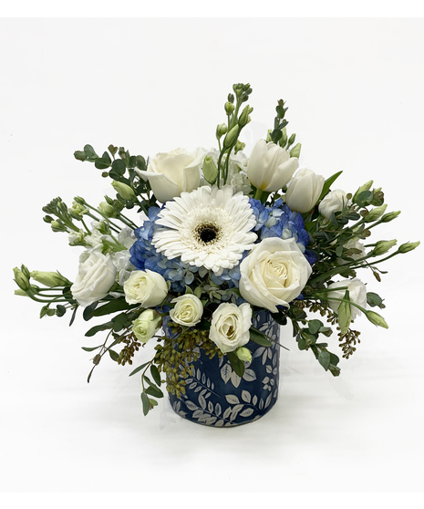white floral arrangement with blue accents