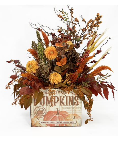 pumpkin themed container with fall-toned flowers